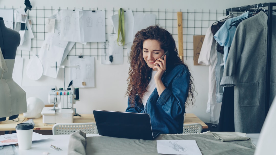 ai-marketing-content-featured.jpg Fashion designer on the phone, working on a laptop