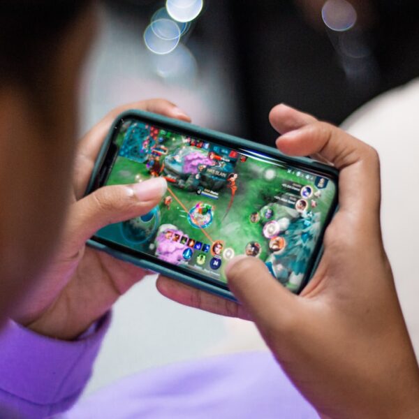 a person holding a cell phone in their hands