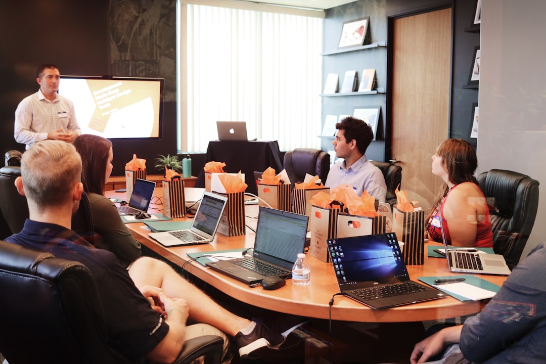 leadership-stories-2026-featured.jpg man standing in front of people sitting beside table with laptop computers